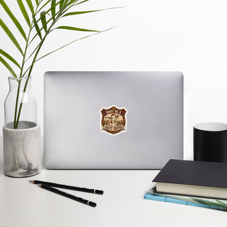 Don't Be a Salty Heifer sticker on laptop lifestyle shot